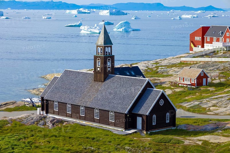 Typical architecture of Greenland Ilulissat with colored houses located near fjords and icebergs