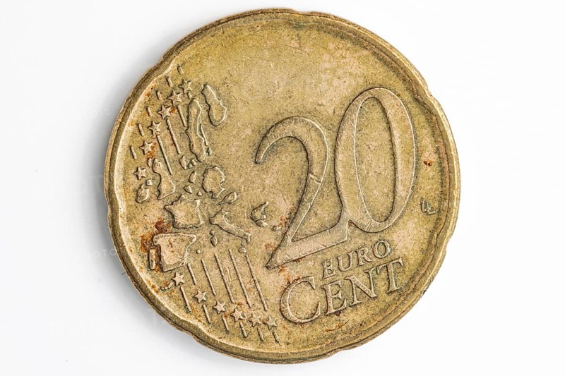 Close-up of the front of a used 20 cent coin, white background