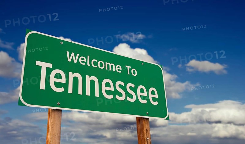Welcome to tennessee green road sign over blue sky with some clouds