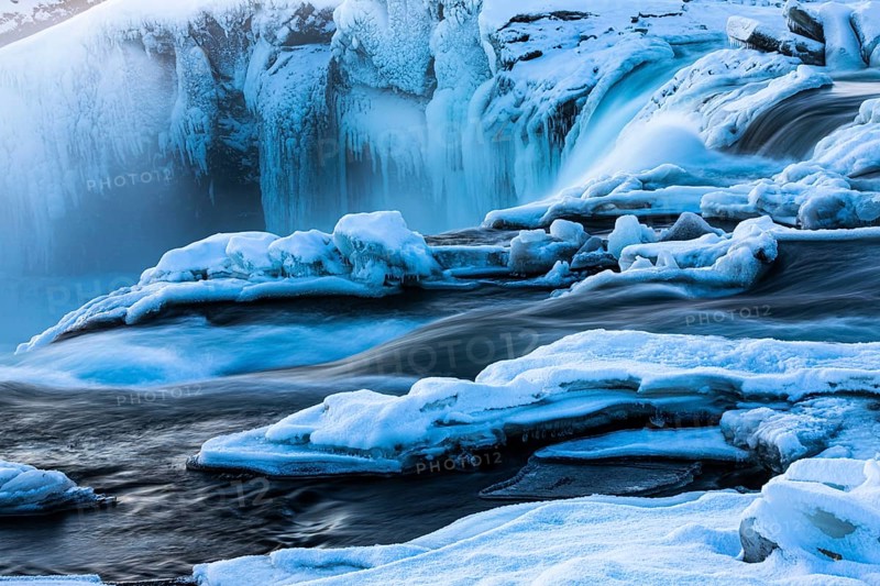 Icefall at the edge of the Godafoss waterfall at dawn, snow-covered landscape, Northern Iceland Eyestra, Iceland, Europe