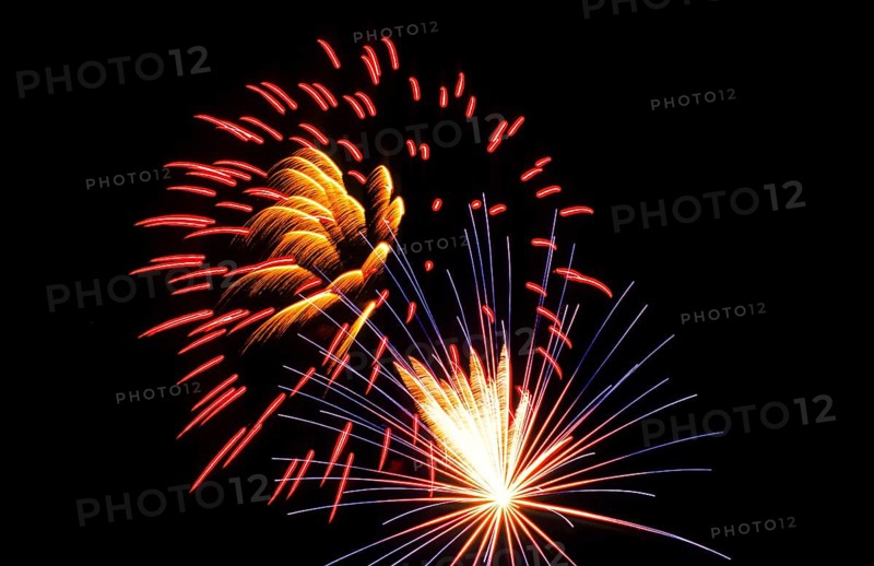 New Year's Eve fireworks, vivid fireworks in the night sky with golden, yellow, red and blue streaks of light and sparks, many fireworks, rockets, New Year's Eve rockets in the dark, sparkling trails of light in the dark sky, stars, star-shaped, shining lights, pyrotechnics, Germany, Europe