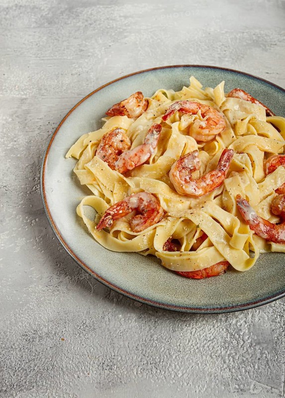Tagliatelli with shrimp, in cream sauce, with parmesan cheese, homemade, no people, in