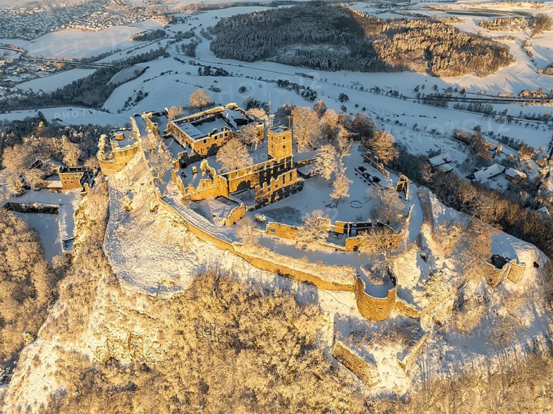 Aerial view of the snow-covered Hegau volcano Hohentwiel with Germany's largest castle ruins on a cold winter morning, at sunrise, district of Constance, Baden-Württemberg, Germany, Europe