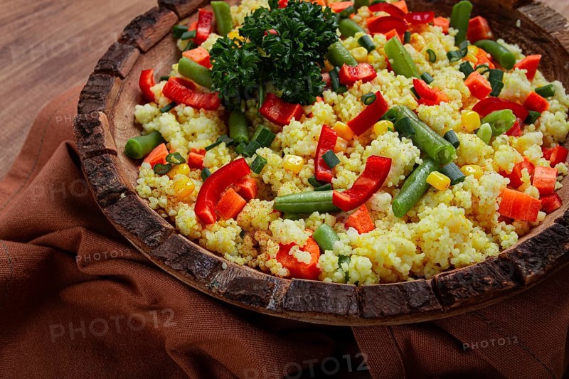 Couscous with vegetables, paprika, carrots, string beans, corn, homemade, top view, no people