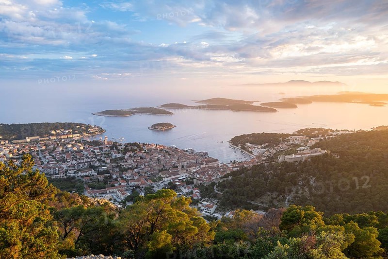 View of the old town centre of Hvar at sunset, behind Pakleni or Paklinski Islands, Dalmatia, Croatia, Europe