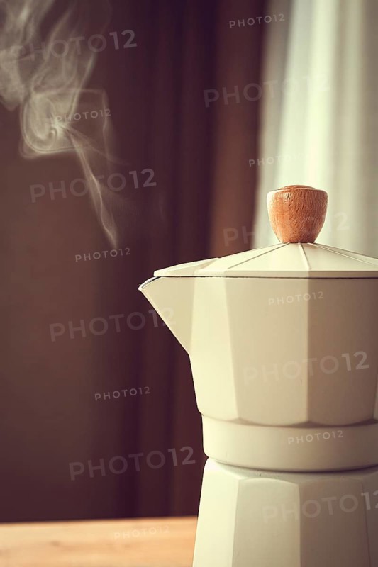 Geyser coffee maker, beige, close-up, boiling, steam from the spout, morning, breakfast, no people