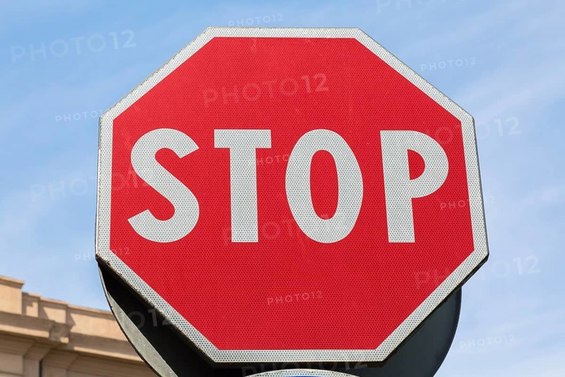 Close-up of red and white traffic stop sign made of reflective material, Messina, Sicily, Italy, Europe