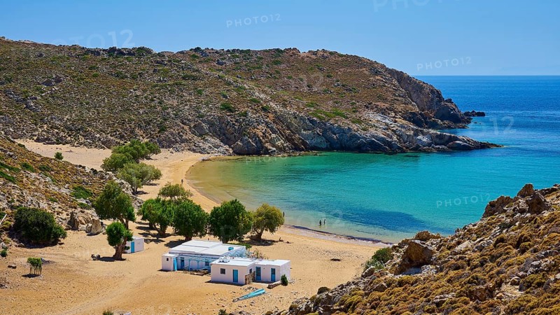 Secluded bay with clear water and golden sand, houses and trees, embedded in a rocky landscape under a bright sky, tamarisk trees, taverna, Psili Ammos Srand, Patmos, Dodecanese, Greek Islands, Greece, Europe