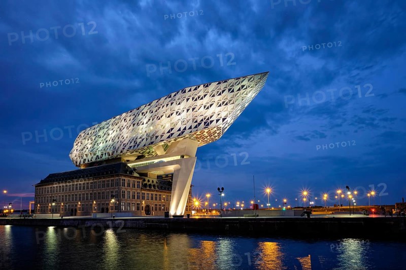 ANTWERP, BELGIUM, MAY 27, 2018: Antwerp port administration headquarters, designed by famous iranian architect Zaha Hadid, Antwerpen, Belgium illuminated at night