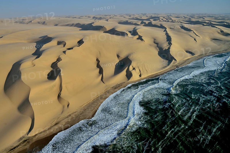 Aerial view, dunes in Namib desert, Atlantic Ocean, waves breaking on Namibian coast south of Sandwich Harbour, Namib-Naukluft National Park, Namibia, Africa