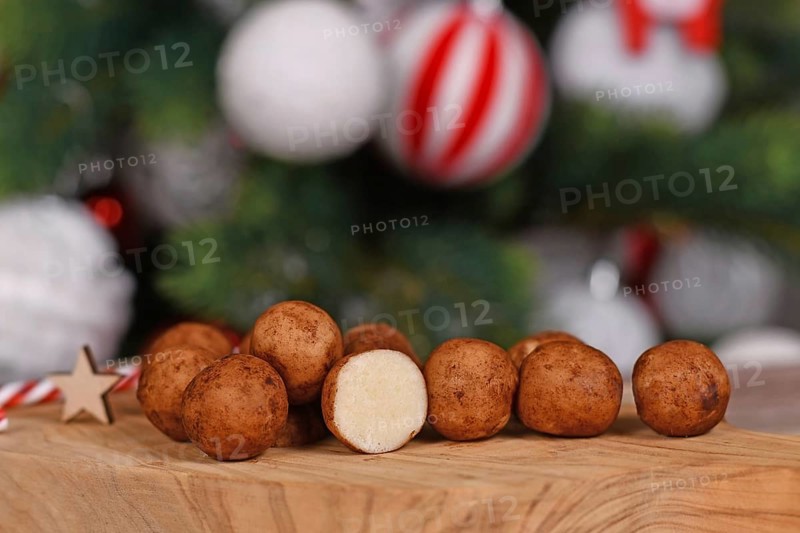 Traditional German Christmas sweets called 'Marzipankartoffeln'. Round ball shaped almond paste pieces covered in cinnamon and cocoa powder