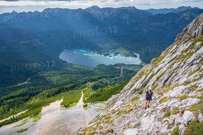 Via ferrata over the Riffelscharte, hiker in the mountains, view of Eibsee lake and Werdenfelser Land, Wetterstein Mountains, Garmisch-Patenkirchen, Bavaria, Germany, Europe