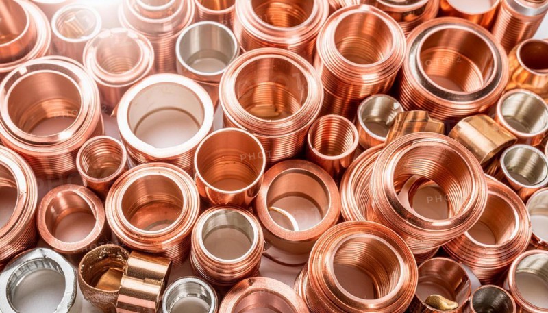Material, metal, copper, a large quantity of pipes and pipe sections, production waste, made of copper on a stockpile for recycling
