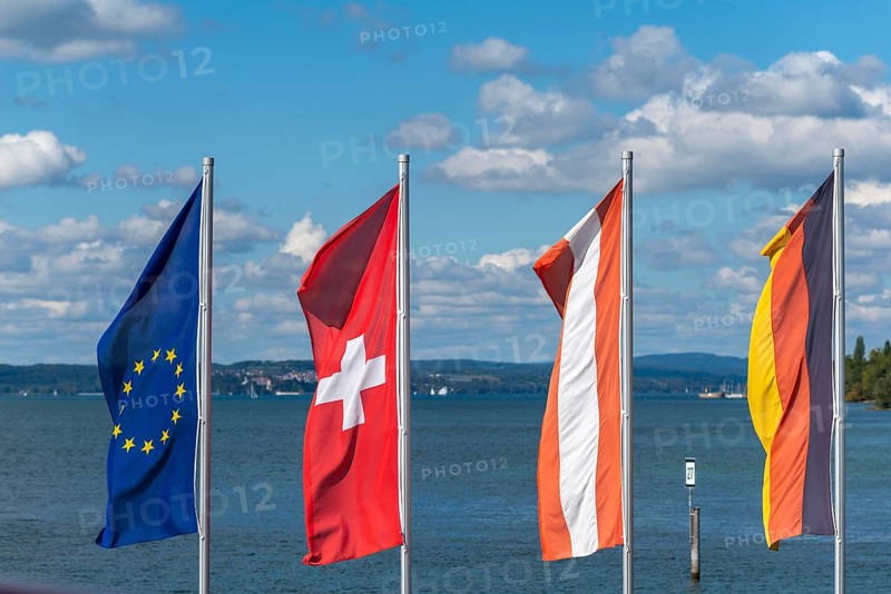 Waving flags, Europe, Switzerland, Austria, cityscape, blue sky, Hagnau on Lake Constance, Baden-Württemberg, Germany, Europe