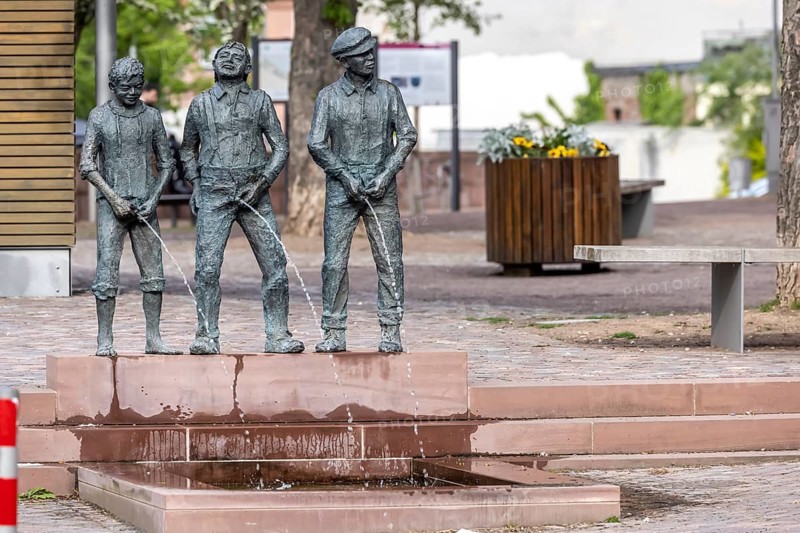 Staffelbrunserbrunnen Miltenberg. The fountain figures depict three boys urinating in a pool of water. Miltenberg, Lower Franconia, Bavaria, Germany, Europe