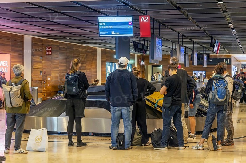 Berlin-Brandenburg BER Airport. Passengers waiting for their suitcases at baggage reclaim. Berlin, Germany, Europe
