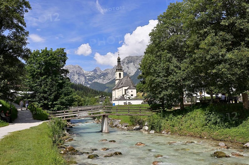 Parish church of St. Sebastian in autumn with Ramsauer Ache, Reiteralpe in the background, Ramsau, Berchtesgaden, Berchtesgadener Land, Upper Bavaria, Bavaria, Germany, Europe