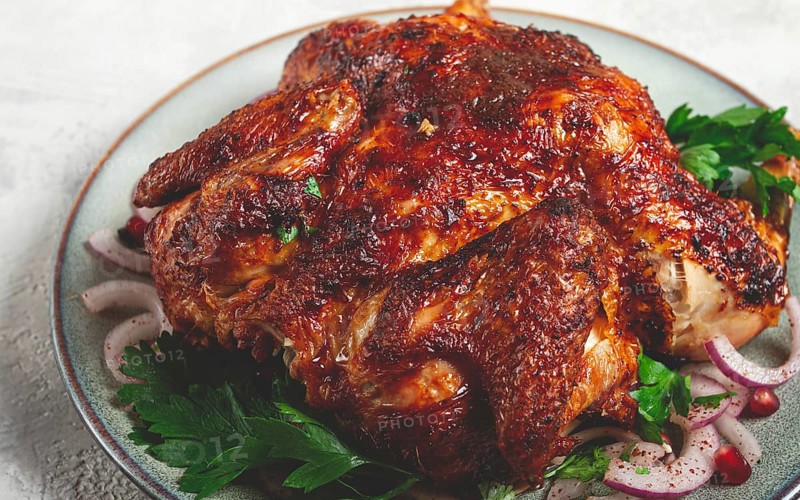 Whole fried chicken, with spices, grilled chicken, on a light background, top view, homemade, no people