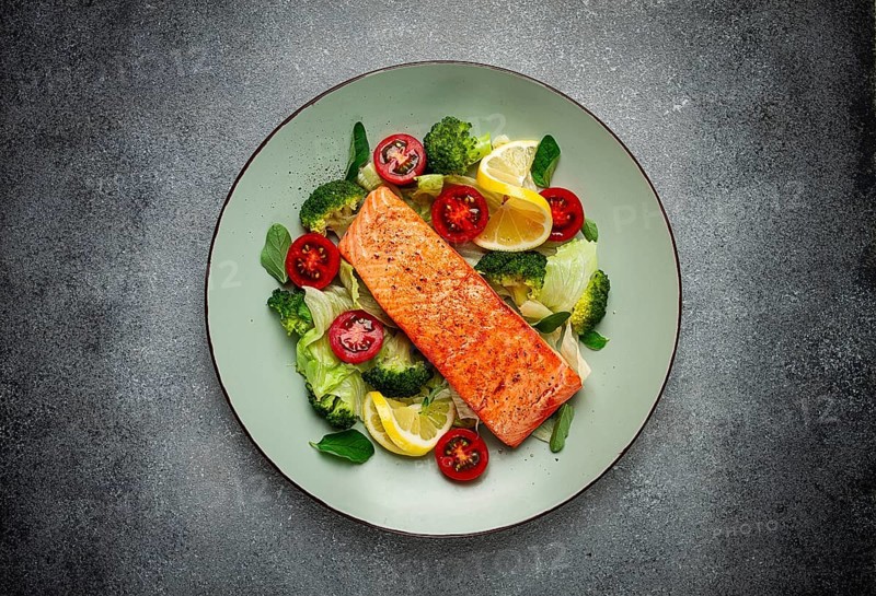 Grilled salmon fillet, with vegetables, broccoli, cherry, iceberg lettuce, spices and herbs, homemade, no people