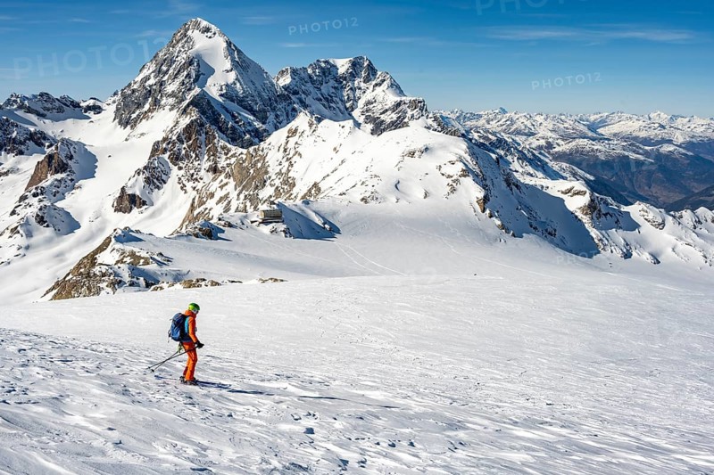 Mountaineer exploring a snow-covered landscape with impressive mountain peaks in the background, descent of the ski tour to Monte Cevedale, Ortler Alps, Italy, Europe