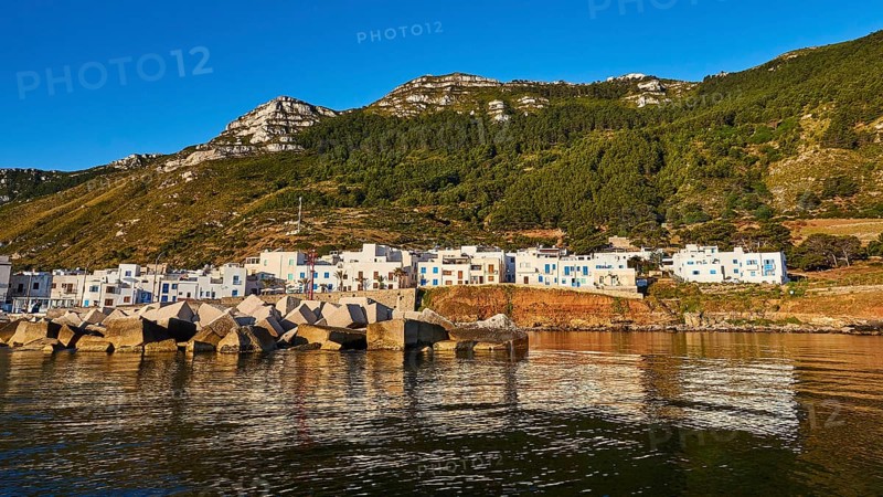 Concrete breakwater, White houses, Wooded hillside, Mountain, Morning light, Marettimo village, Marettimo, Egadi Islands, Sicily, Italy, Europe