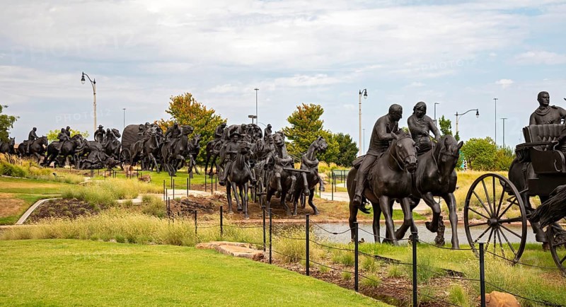 Oklahoma City, Oklahoma - A sculpture commemorates the Oklahoma Land Run of 1889 when thousands of settlers were allowed to enter former Indian Territory and stake claims to the land. The sculpture, by artist Paul Moore, includes 45 figures stretching 365 feet along the Bricktown Canal.
