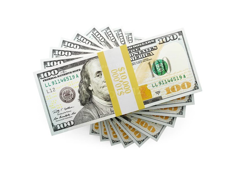 Overhead of one hundred thousand dollars spiralling stacks of one hundred dollar bills isolated on a white background.