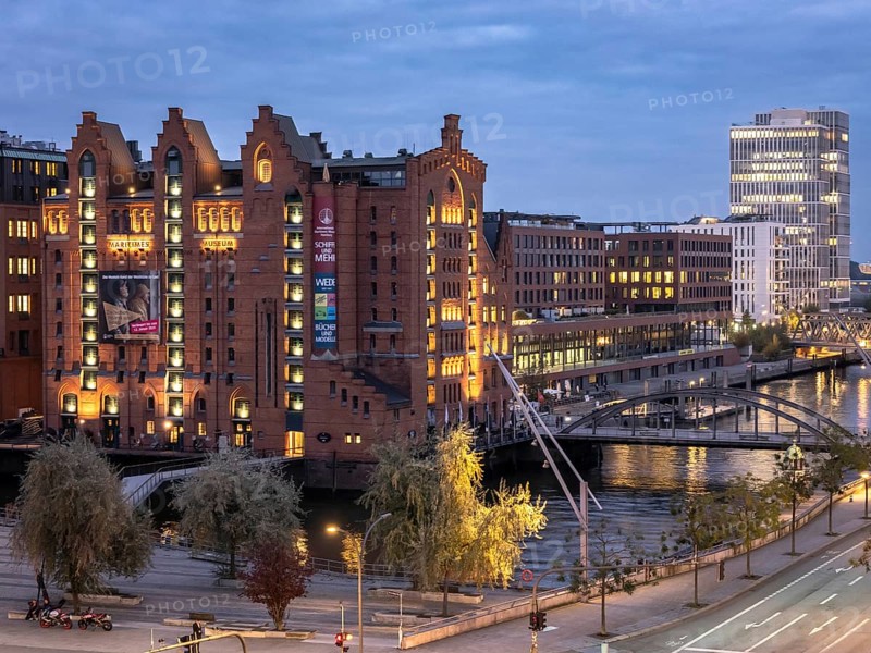 Aerial view of the International Maritime Museum Hamburg with Elbe barques surrounded by trees at blue hour at dusk, Speicherstadt, Hamburg, Germany, Europe