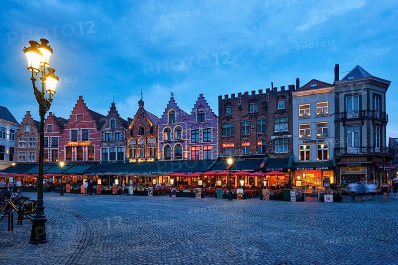 Bruges, Belgium, May 29, 2018: Bruges Grote markt square famous tourist place with many cafe and restaurants in the evening night twilight, Europe