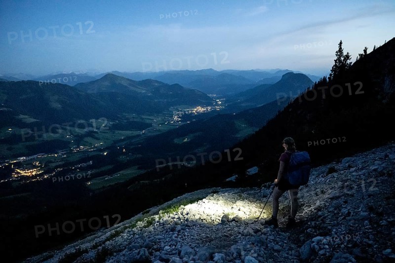 Female mountaineer hiking at night with a torch, Kaisergebirge, Wilder Kaiser, Kitzbühel Alps, Tyrol, Austria, Europe