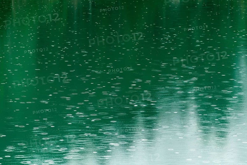 Raindrops on emerald green reservoir, Stillup reservoir, Stilluptal, Mayrhofen, High Mountain nature park Park Zillertal Alps, light reflections, Tyrol, Austria, Europe