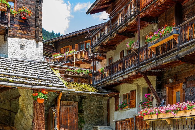 Nested old wooden houses with flower boxes in front of windows and balconies, historic village centre, Grimentz, Val d'Anniviers, Valais Alps, Canton Valais, Switzerland, Europe