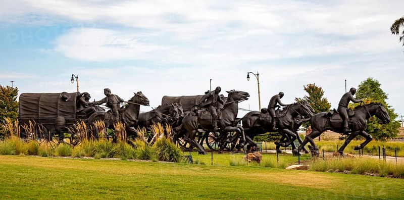 Oklahoma City, Oklahoma - A sculpture commemorates the Oklahoma Land Run of 1889 when thousands of settlers were allowed to enter former Indian Territory and stake claims to the land. The sculpture, by artist Paul Moore, includes 45 figures stretching 365 feet along the Bricktown Canal.