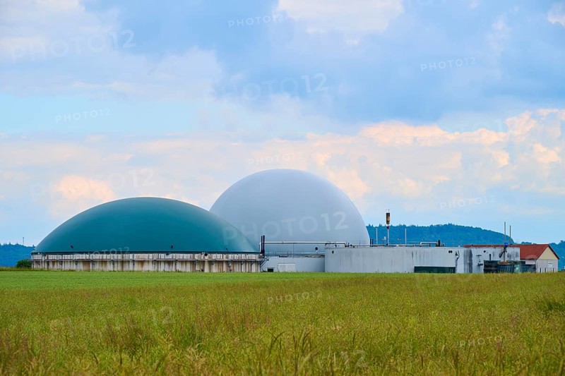Modern biogas plant in the middle of green fields under a cloudy blue sky, summer, Middle Franconia, Bavaria, Germany, Europe