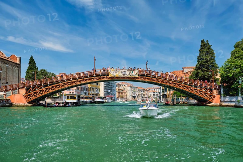 VENICE, ITALY, JULY 19, 2019: Ponte dell'Accademia bridge with boat passing under on Grand Canal, Venice, Italy, Europe