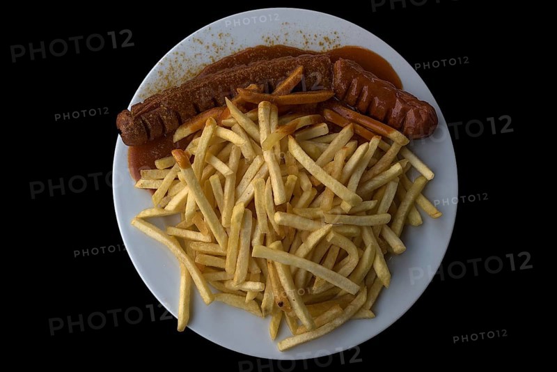 Currywurst with fries on a black background, Bavaria, Germany, Europe