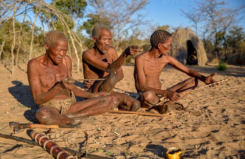 Bushmen of Ju/' Hoansi-San sitting on the ground, village //Xa/oba, near Tsumkwe, Otjozondjupa region, Namibia, Africa