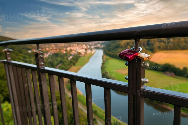 Two love locks on the railing, view from the skywalk onto the Weser towards Bad Karlshafen in the evening, Beverungen, Höxter, East Westphalia, Weserbergland, North Rhine-Westphalia, Germany, Europe