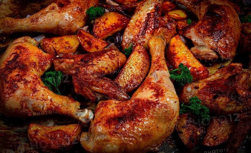 Roast chicken legs with potatoes and onions in the oven, homemade. No people
