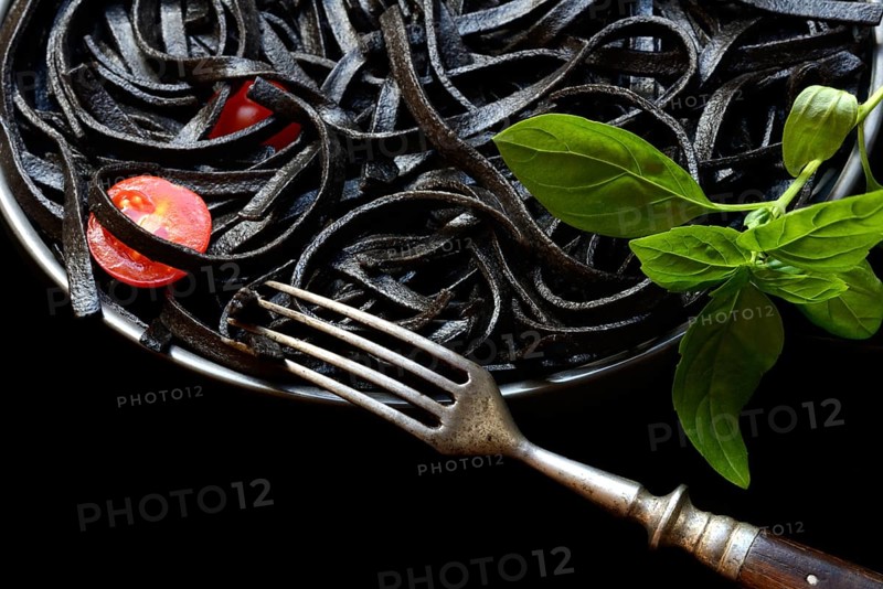 Black pasta coloured with squid ink on a plate, Taglioni al Nero di Seppia, Italy, Europe