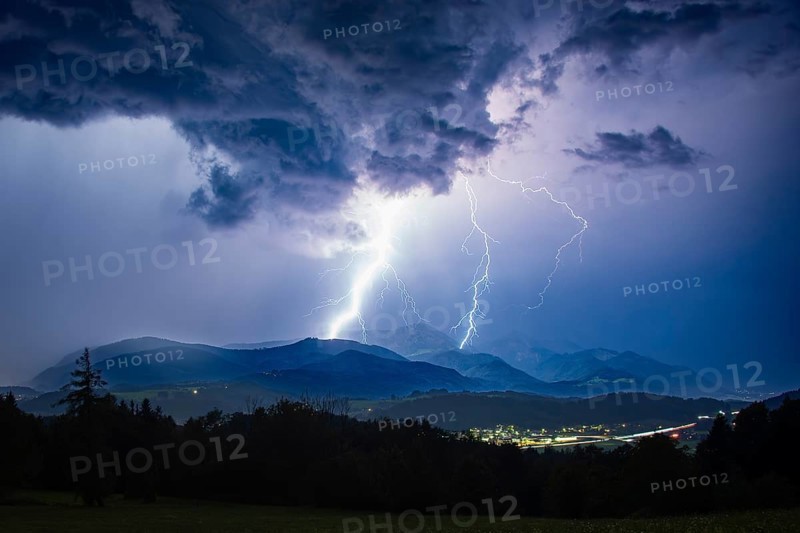 Lightning during a heavy thunderstorm over Siegsdorf and the Hochfelln, Chiemgau Alps, Bavaria, Germany, Europe