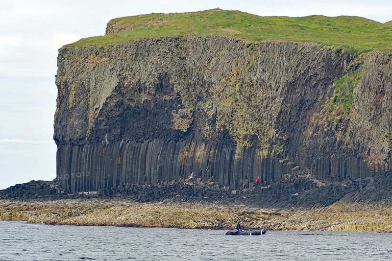 A coastline with prominent basalt cliffs and green grassland above, Hebridean Overture, Isle of Staffa, Inner Hebrides, Scotland, United Kingdom, Europe