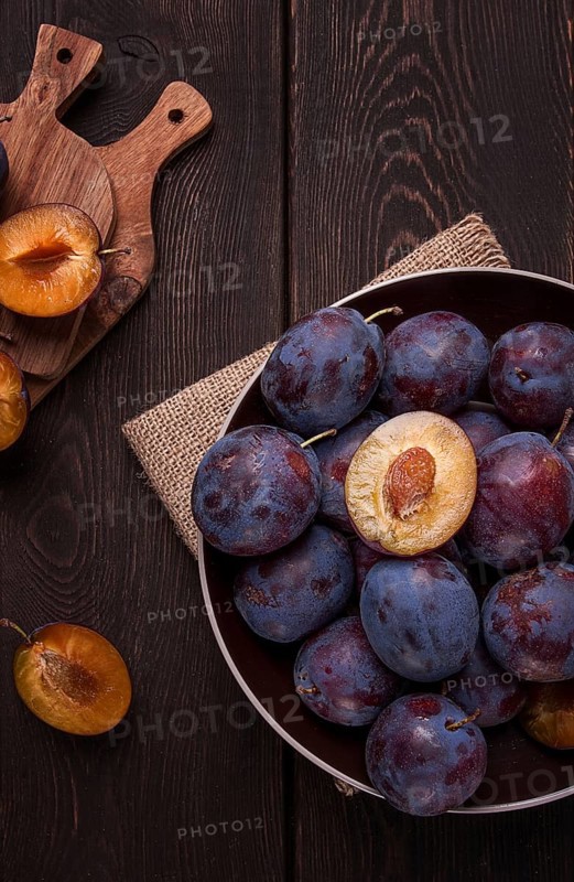 Blue plum, on a wooden table, top view, close-up, no people