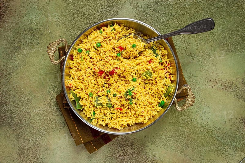 Rice with saffron and vegetables, in a frying pan, top view, homemade, no people