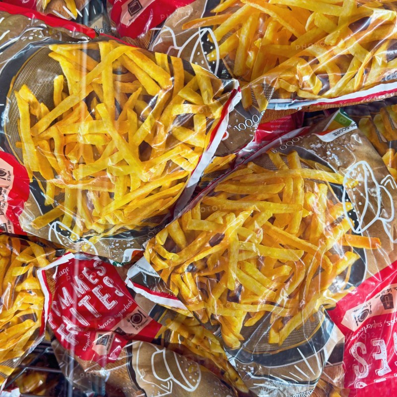 Display of deep-frozen French fries in freezer cabinet with transparent lid of supermarket, Germany, Europe