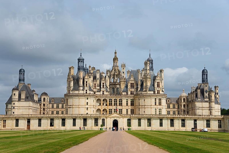 Historic castle with imposing architecture and elaborate towers under a cloudy sky, surrounded by a huge green area, Chambord Castle, Château de Chambord, Loire Castle, Loire Valley, Loir-et-Cher Department, Centre Region, France, Europe