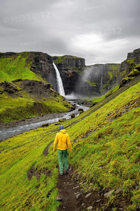 Hikers in a green canyon, Haifoss and Granni waterfall at a canyon, Fossá í Þjórsárdal, with river í Þjórsárdal, long exposure, dramatic landscape, Hekla, Iceland, Europe
