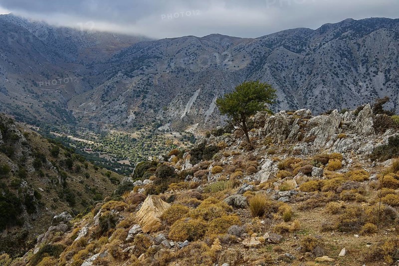 Calm mountain scene with rocky foreground and a weather-beaten sky, Kallikratis, Kallikratis Gorge, Sfakia, West Crete, Crete, Greek Islands, Greece, Europe