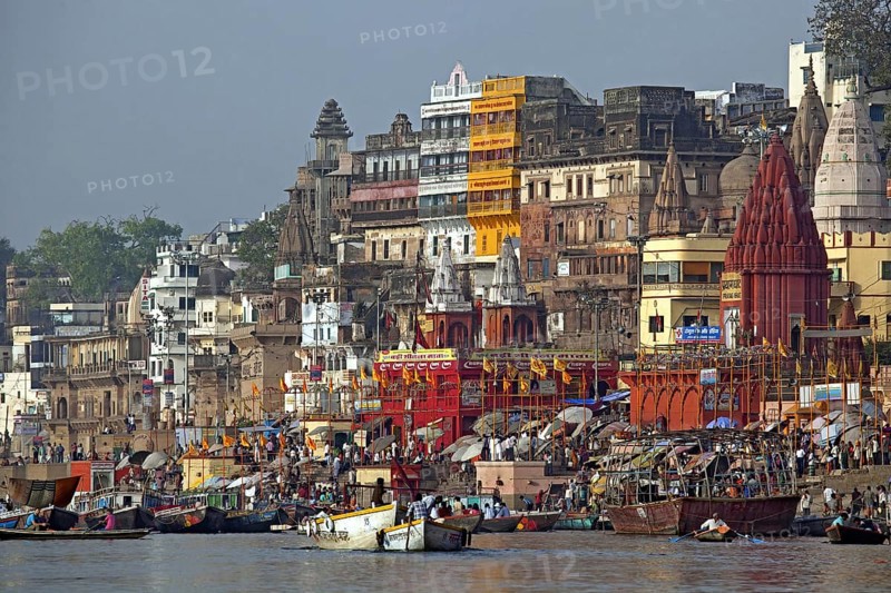 Holy city and colourful rowing boats on the Ganges river at Varanasi, Uttar Pradesh, India, Asia