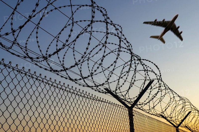 Symbolic image, deportation flights of illegal and delinquent migrants, passenger aircraft, airport, security fence, barbed wire, Germany, Europe
